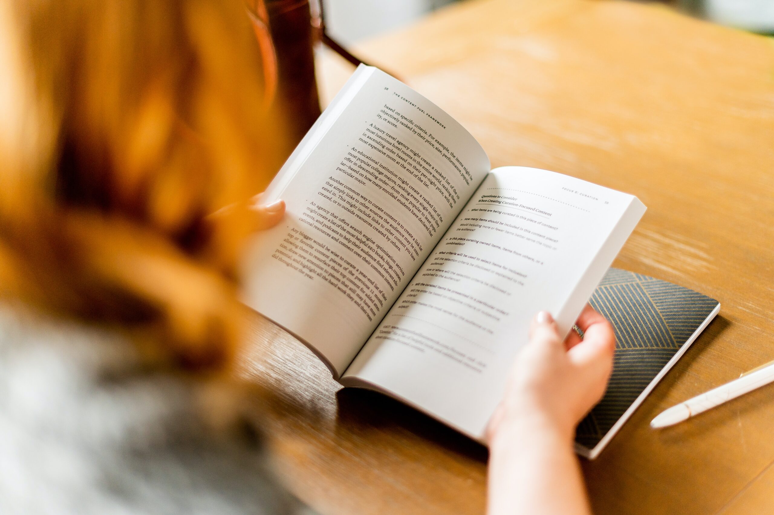 Red-haired woman reading a book