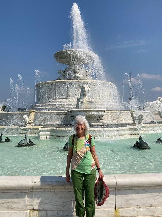 Sandra Krafsur smiling in front of a fountain